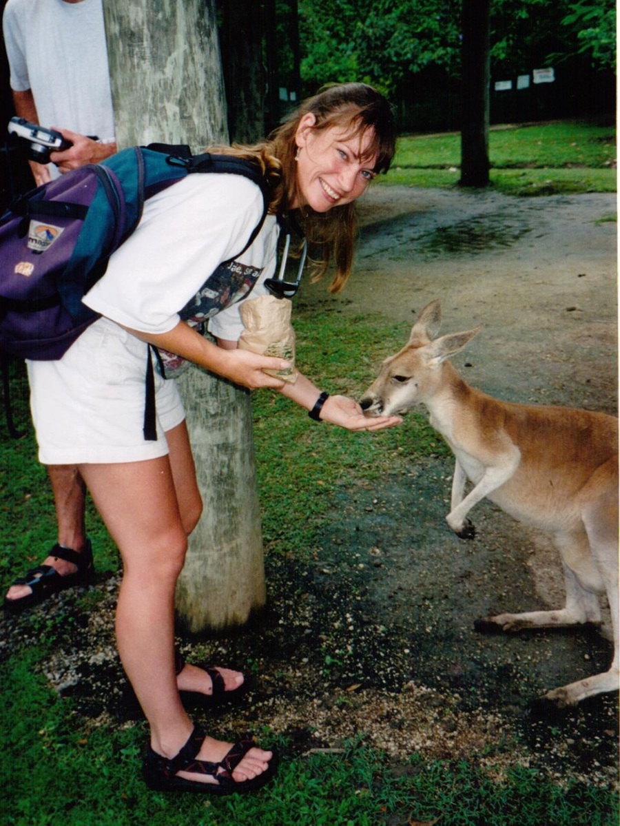 Jackie Lambert, the author, hand feeding a kangaroo on a crazy backpacking trip around Australia