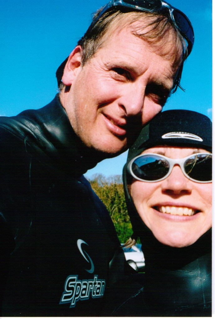Author Jacqueline Lambert and husband Mark wearing winter wetsuites