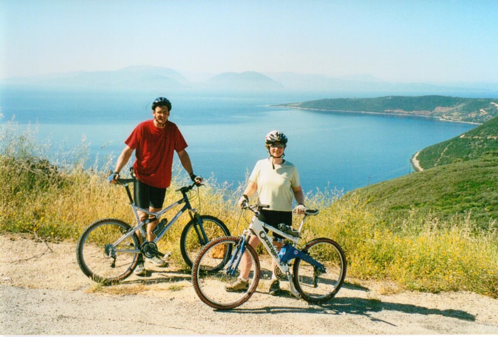 Author Jacqueline Lambert with husband Mark on bicycles in the Greek islands