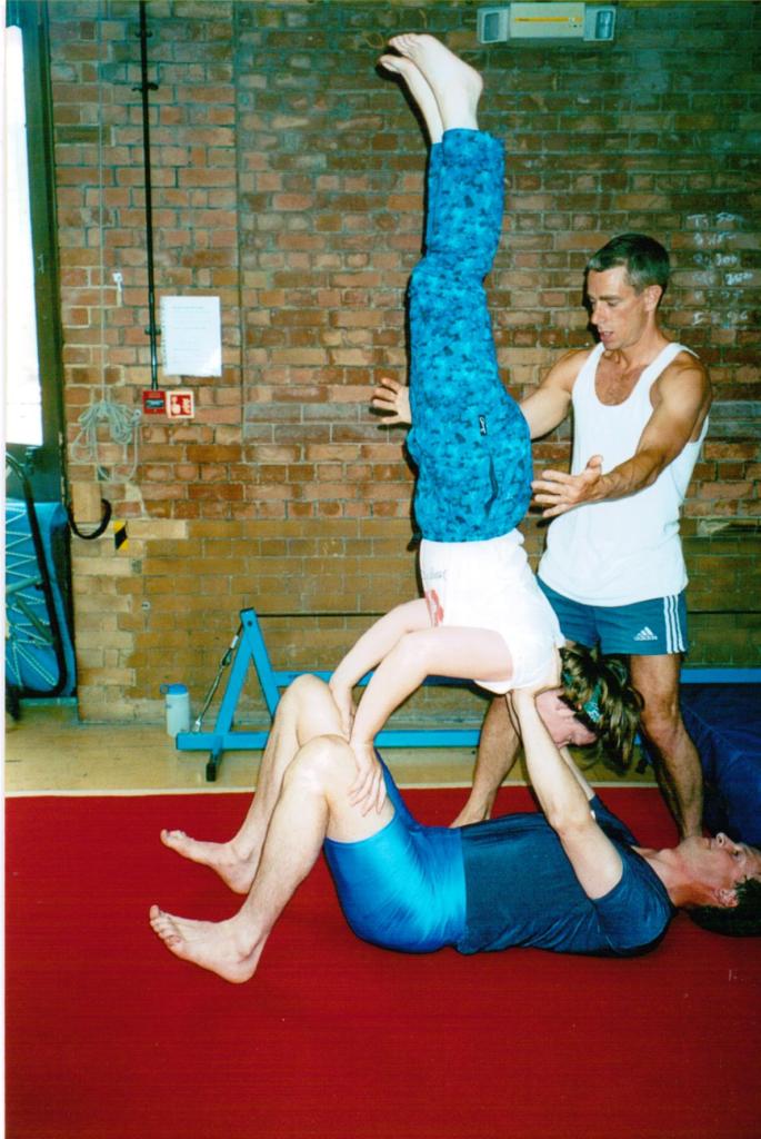 Author Jacqueline Lambert balanced doing a handstand on husband Mark in a circus skills workshop