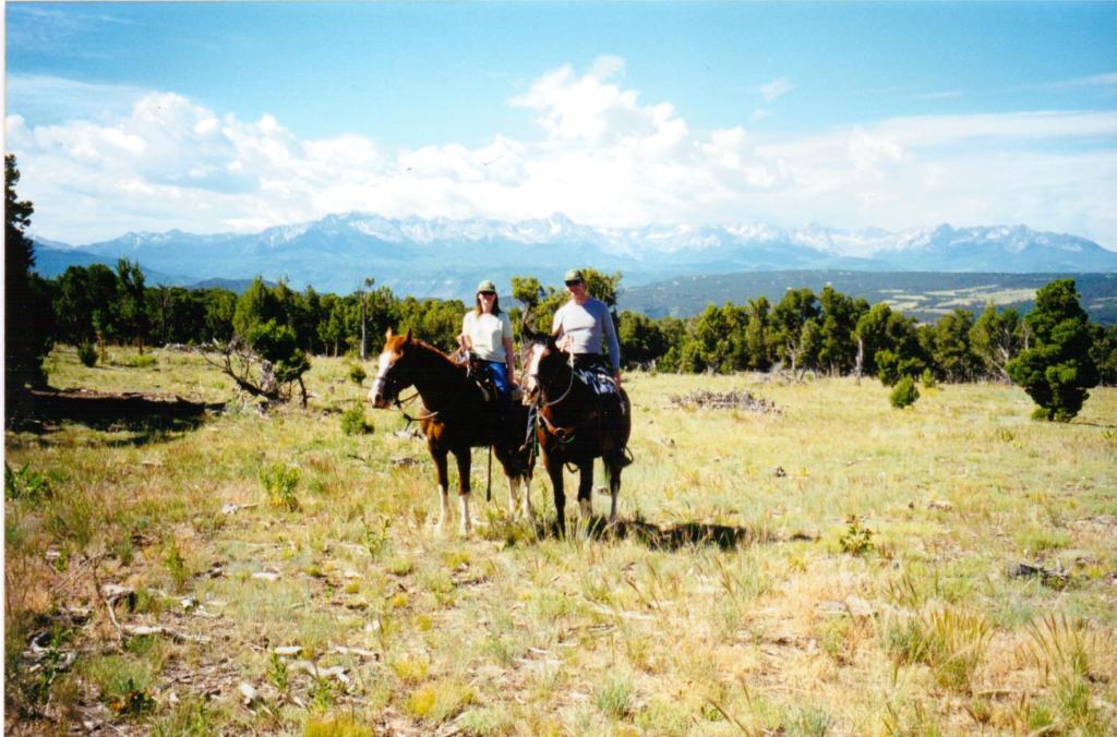 Author Jacqueline lambert and husband Mark on horses in the Rocky Mountains, USA