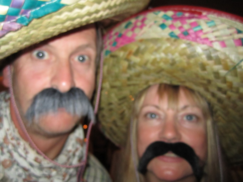 Jacqueline Lambert author with her husband Mark, sporting Mexican moustaches and sombreros
