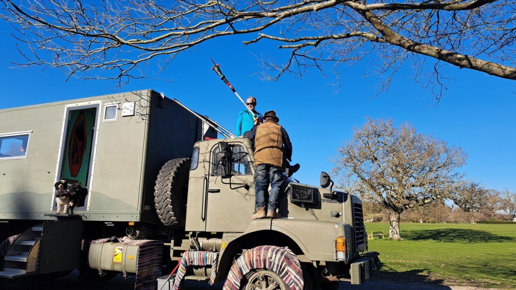 A picture of Mark and another man on the cab of the Beast performing tree surgery. You can just see Mark's crutches on the cab - he was supposed to be resting his broken leg.